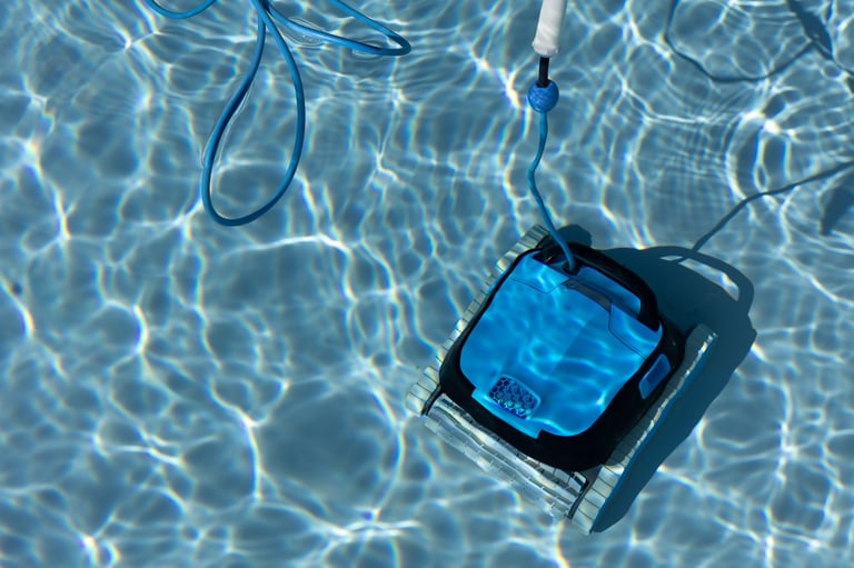 Robotic pool cleaner cleaning the bottom of a swimming pool with clear blue water
